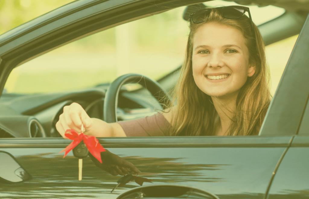 A person holding the keys in their new car